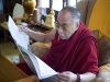 The Dalai Lama reading newspaper